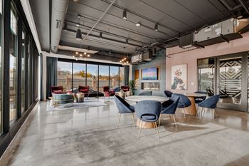 a dining room with a table and chairs in a room with windows